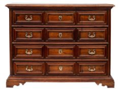An 18th Century Italian provincial walnut commode:, of large size, the top with a moulded edge,