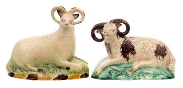 A creamware figure of a reclining ram of Yorkshire type and one similar: the first on mound base