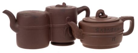 Two Chinese Yixing stoneware teapots: one of mid brown hue of squat and banded cylinder form with