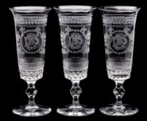 A set of nine etched glass flutes: the mildly flaring bowls engraved with the initials K.S.D.