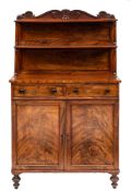A William IV mahogany chiffonier: the graduated two tier shelved superstructure with panel backs