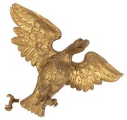 A carved giltwood figure of an eagle in the Regency style:,