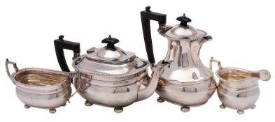 A George V silver four- piece tea service, maker Harrods, Birmingham, 1935: of barge-shaped outline,
