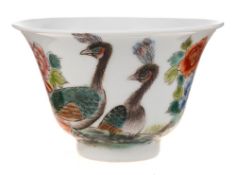 A small Chinese famille rose bowl: with flaring rim, painted with two peacocks amongst peony,