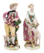 A pair of Chelsea-Derby figures of a shepherd and shepherdess: she wearing a green bodice and