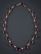 An early 20th Century gold, amethyst and seed-pearl necklace: with graduated,