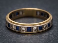 A blue and white spinel mounted eternity ring: stamped '18ct', approximately 4gms gross weight,