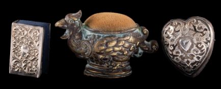 A silver mounted pin cushion, marks worn: of heart-shaped outline,