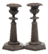 A pair of French Restauration bronze candlesticks: with spiral reeded columns and hexagonal bases,