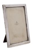 A George V silver easel photograph frame, maker E Mander & Son, Birmingham, 1917: 21 x 14.5cm.