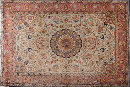 A Tabriz carpet:, the pistachio field with a central circular geometric flowerhead pole medallion,