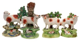 Two Walton pearlware ram and ewe bocage groups and two similar: each with a lamb lying amongst