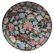 A Chinese famille noire millefleurs charger: painted with lotus, peony,