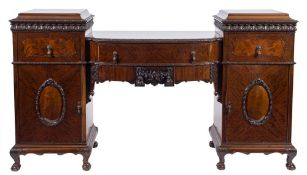 A 1920's carved mahogany dining suite in the George II taste:,