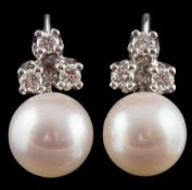 A pair of cultured pearl and diamond ear studs: each set with a single cultured pearl approximately