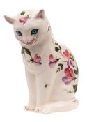 An Exon Ware Wemyss pottery cat: modelled seated with inset blue glass eyes and painted with sweet