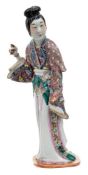 A Chinese porcelain figure of an elegant lady: dressed in flowing robes,