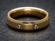 An 18ct gold and diamond four-stone band: set with round brilliant-cut diamonds,