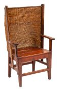 A 19th Century oak and pine Orkney Islands wing armchair:, having a curved ropework back,