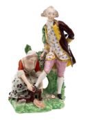 A Derby figural group of the 'Shoeblack': modelled as a gentleman having his shoe polished by a