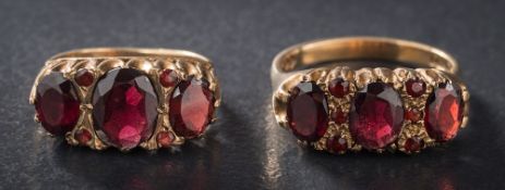 A 9ct gold and garnet mounted nine-stone ring: and a similar smaller seven-stone ring.