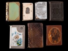A collection of seven assorted book-shaped vesta cases: including ivory and horn examples (7).