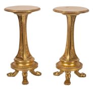 A pair of carved giltwood circular pedestal tables:, the tops with egg and dart borders,