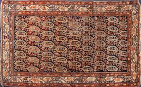A Melayer rug:, the shaded field with an all over design of geometric boteh,