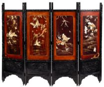 A Japanese carved and ebonised four fold screen:,
