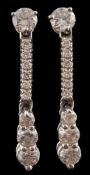 A pair of hallmarked 18ct white gold and diamond drop earrings: each set with a single round