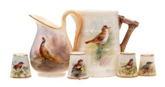 A small group of Royal Worcester miniature bird painted pieces: comprising four thimbles and a