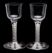 A pair of English opaque twist wine glasses: each with ogee shaped bowl on a straight double series