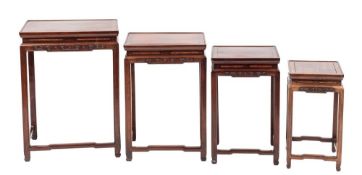 A set of Chinese rosewood quartetto tables:, having rectangular tops and cloud band aprons,