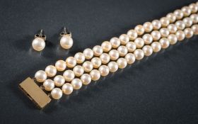 A cultured pearl three-string necklace: the cultured pearls approximately 7mm diameter and on