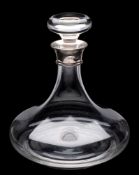 A clear glass ship's decanter: with simple mushroom stopper and silver mounted neck, J.A.