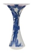 A Japanese blue and white trumpet-shaped vase: in Fukagawa style, painted with a large pine tree,