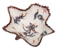 A Plymouth leaf shaped pickle dish: painted in underglaze blue and iron-red with narcissus and
