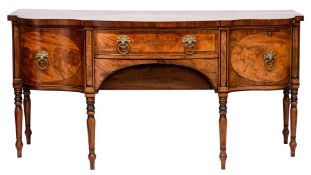 A Regency mahogany and inlaid sideboard:, of shaped serpentine fronted outline,