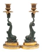 A pair of Regency style brass and bronzed metal metal candlesticks: with urn -shaped nozzles,