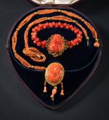A mid 19th Century coral relief mounted necklace: the central coral panel 32mm long x 24mm wide