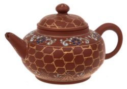 A small Chinese Yixing stoneware teapot: of light brown hue with squat body,