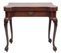A George II carved mahogany triple top games table: with projecting rounded corners,