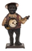A Victorian American Blinking Eye automata clock: the cast iron case depicting a banjo player in