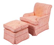 A fully upholstered armchair:, in a coral coloured trailing foliate design with loose cushion seat,