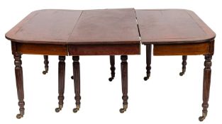 A Regency mahogany and brass inlaid extending dining table:, with a telescopic action,