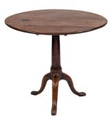 A George III mahogany circular tea table:, the snap top on a turned pillar and tripod splayed base,