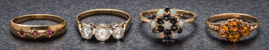 A 9ct gold, sapphire and opal circular cluster ring, a 9ct gold ruby-set 'gypsy' ring,