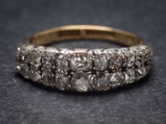 A diamond mounted two-row half-hoop ring: with graduated 'Peruzzi'-cut diamonds estimated to weigh