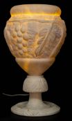 A late Victorian alabaster table lamp: of ovoid outline with low relief decoration of grapes and