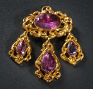 A mid 19th Century gold and foiled amethyst oval brooch: with three drops,